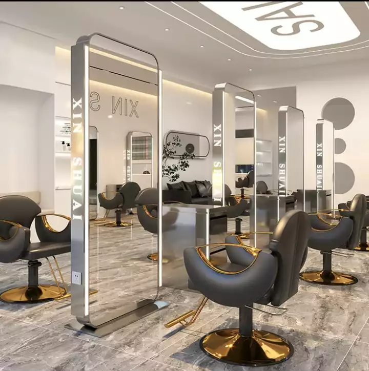 the interior of a salon with chairs and mirrors