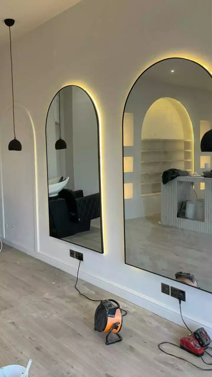 a room with three mirrors on the wall